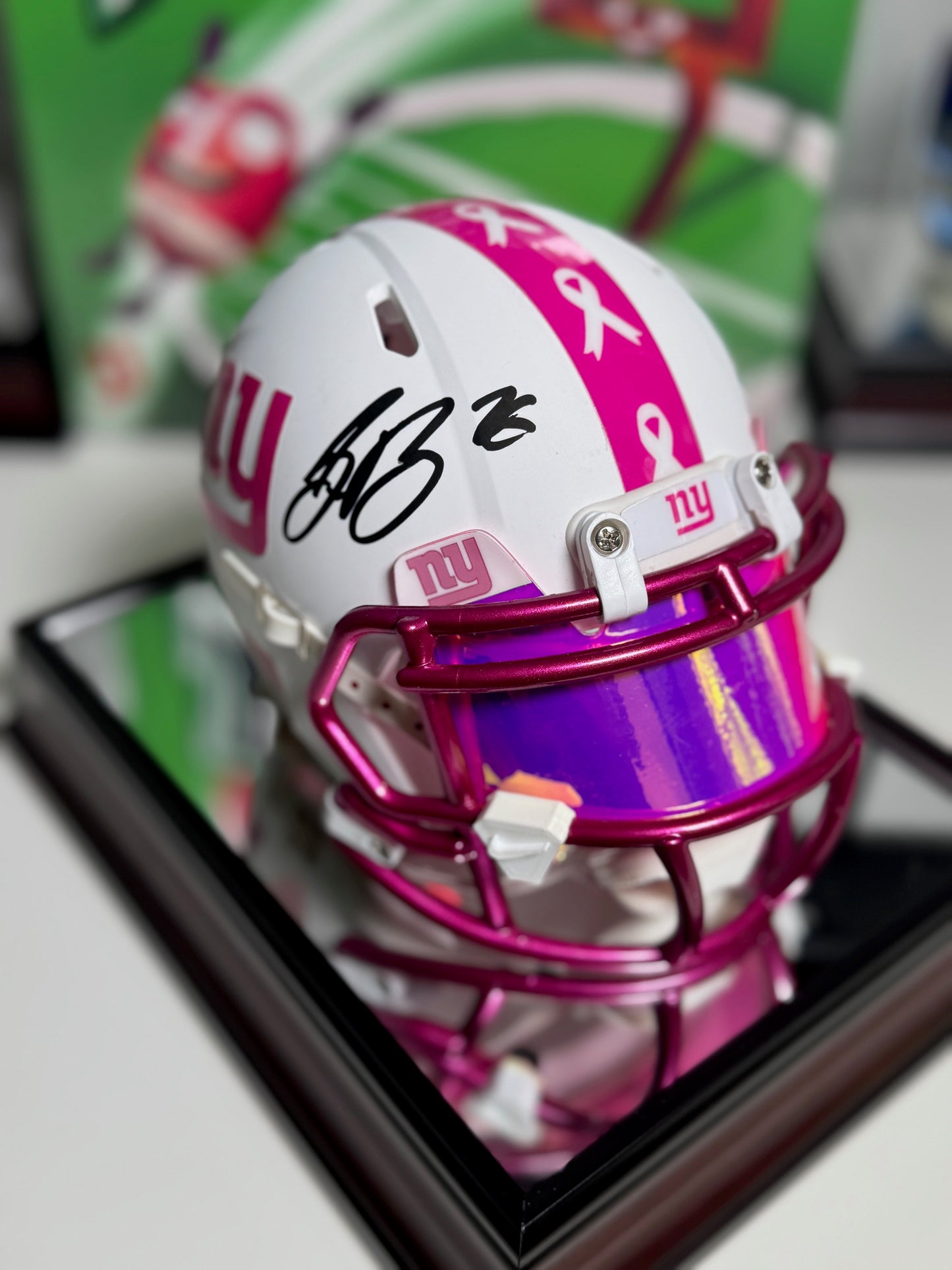 Side view of rare pink mini helmet with custom bumpers and white facemask