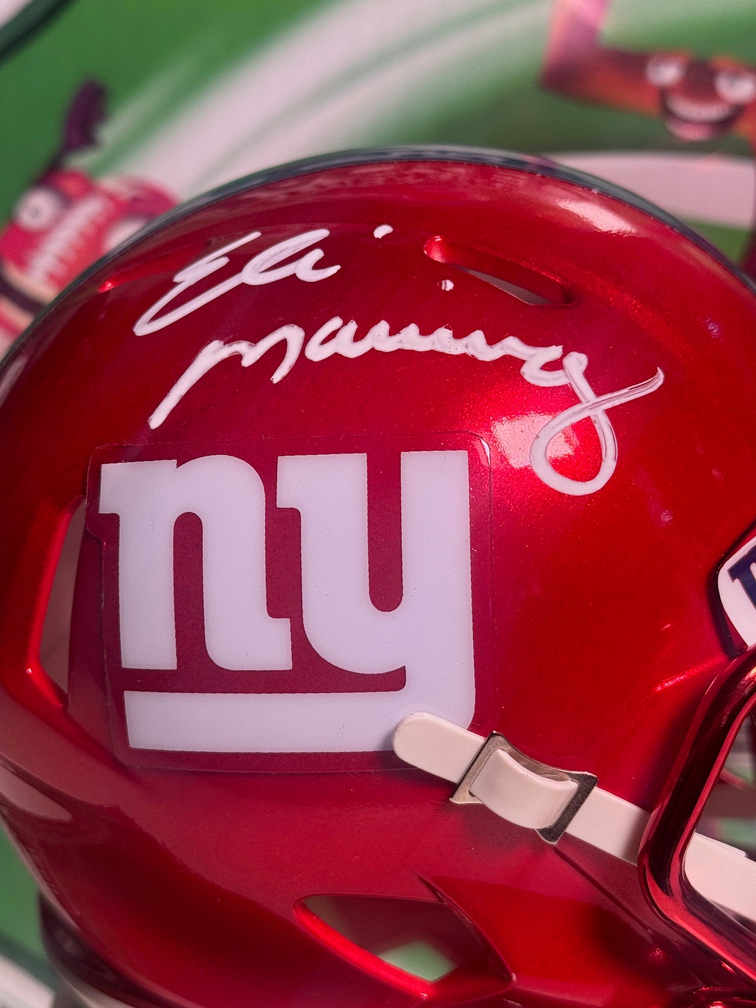 Close-up of Eli Manning autograph on red Giants Flash mini helmet collectible