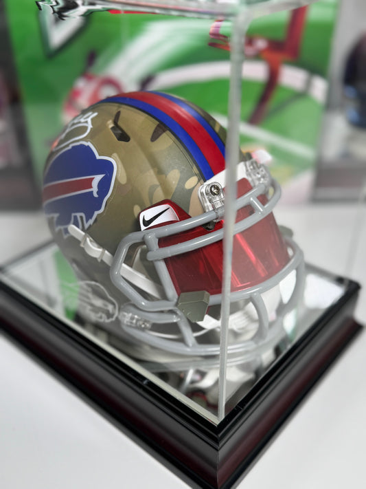 Close-up of Jim Kelly autograph on camo Buffalo Bills mini helmet with red and blue stripe