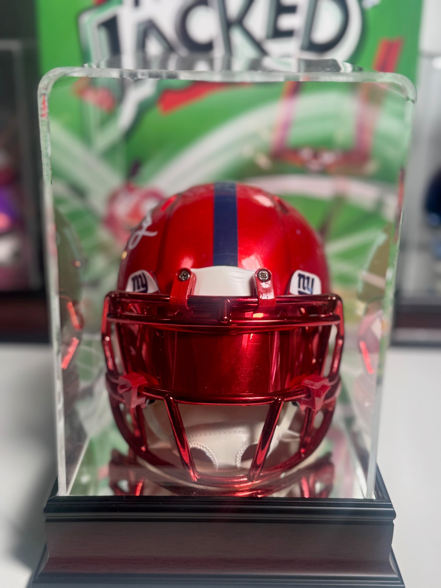 Detail of Eli Manning signature and vivid red and blue design on mini helmet