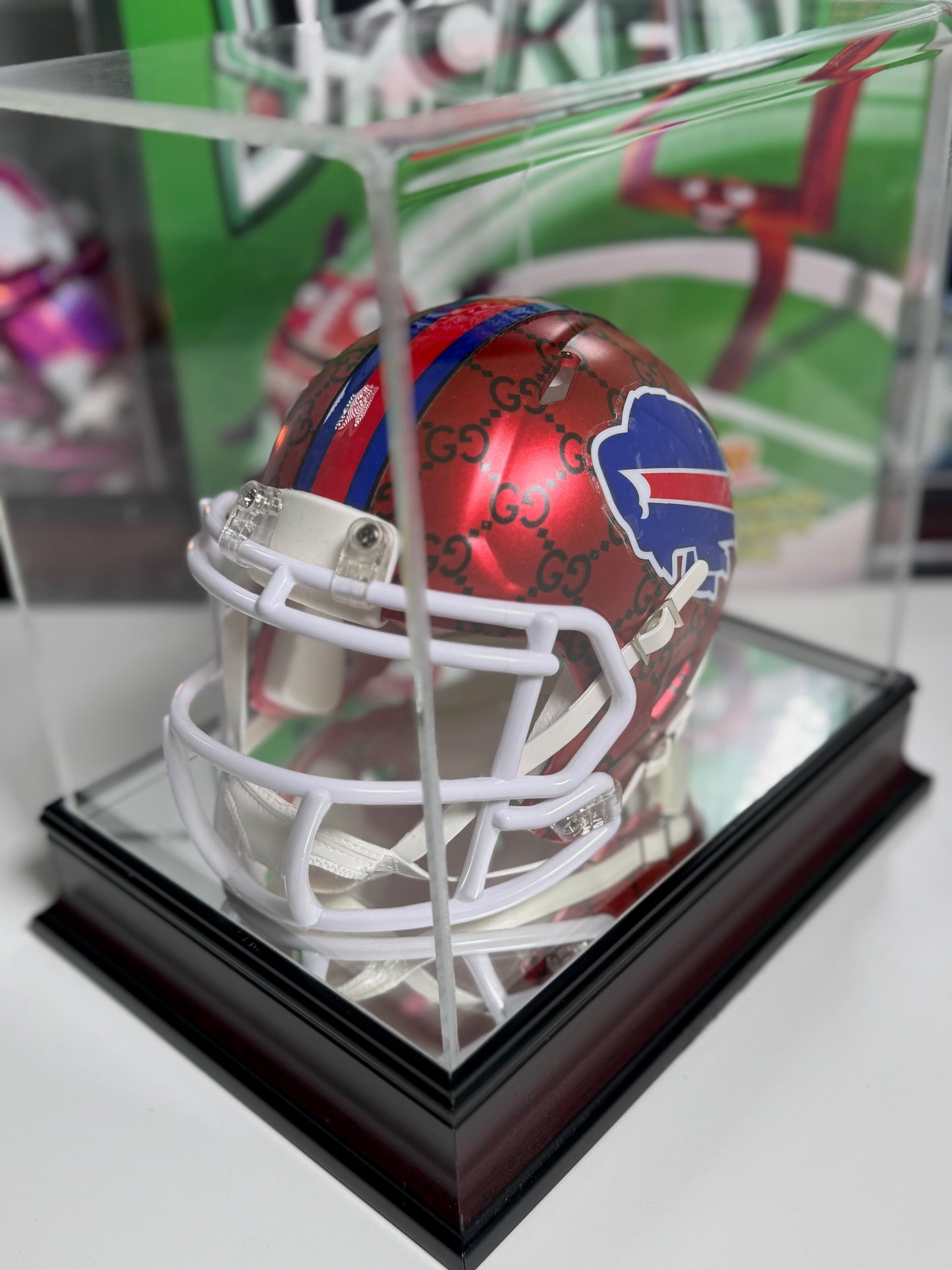 Side view of custom Gucci mini helmet with red and blue stripe and black Gucci pattern

